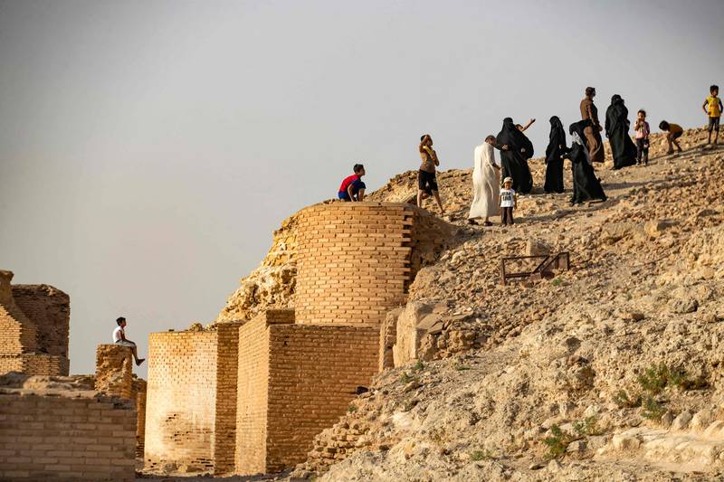 People climb the ruins of Jaabar Citadel.