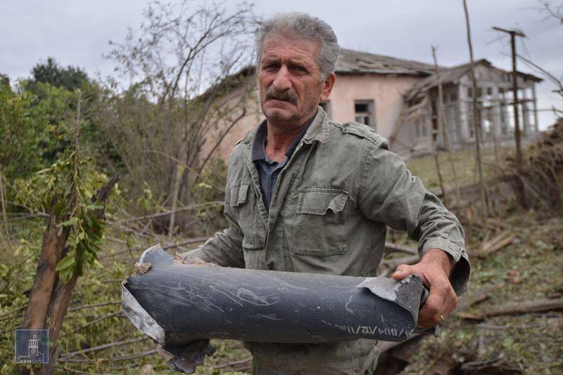 A man holds an ammunition part following what locals say was a recent shelling by Azeri forces, in the town of Martuni in the breakaway Nagorno-Karabakh region, September 28, 2020. Foreign Ministry of Armenia/Handout via REUTERS  ATTENTION EDITORS - THIS IMAGE HAS BEEN SUPPLIED BY A THIRD PARTY. NO RESALES. NO ARCHIVES. MANDATORY CREDIT.