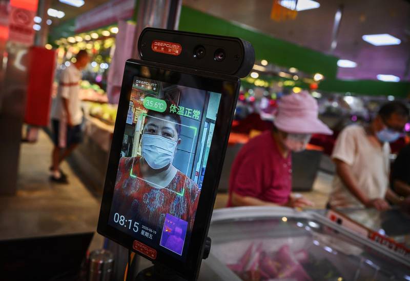 A Chinese woman has her temperature checked by thermal imaging at the entrance to a local market in Beijing, China. Getty Images