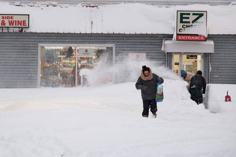 A resident leaves one of a few corner stores in Buffalo, New York, that managed to open. AFP