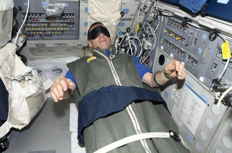 Astronaut Gregory C. Johnson, STS-125 pilot, rests in his sleeping bag on the flight deck of the Earth-orbiting space shuttle Atlantis at the end of flight day 10 in this NASA handout photo taken May 20, 2009.   REUTERS/NASA/Handout     (UNITED STATES SCI TECH) FOR EDITORIAL USE ONLY. NOT FOR SALE FOR MARKETING OR ADVERTISING CAMPAIGNS