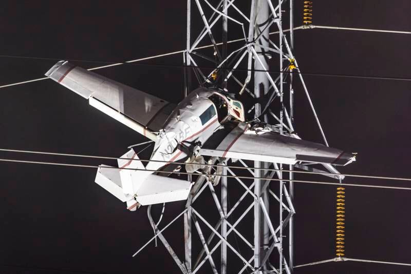 A small plane remains stuck after it crashed into power lines, knocking out electricity for tens of thousands of residents, in Gaithersburg, Maryland, US. EPA

