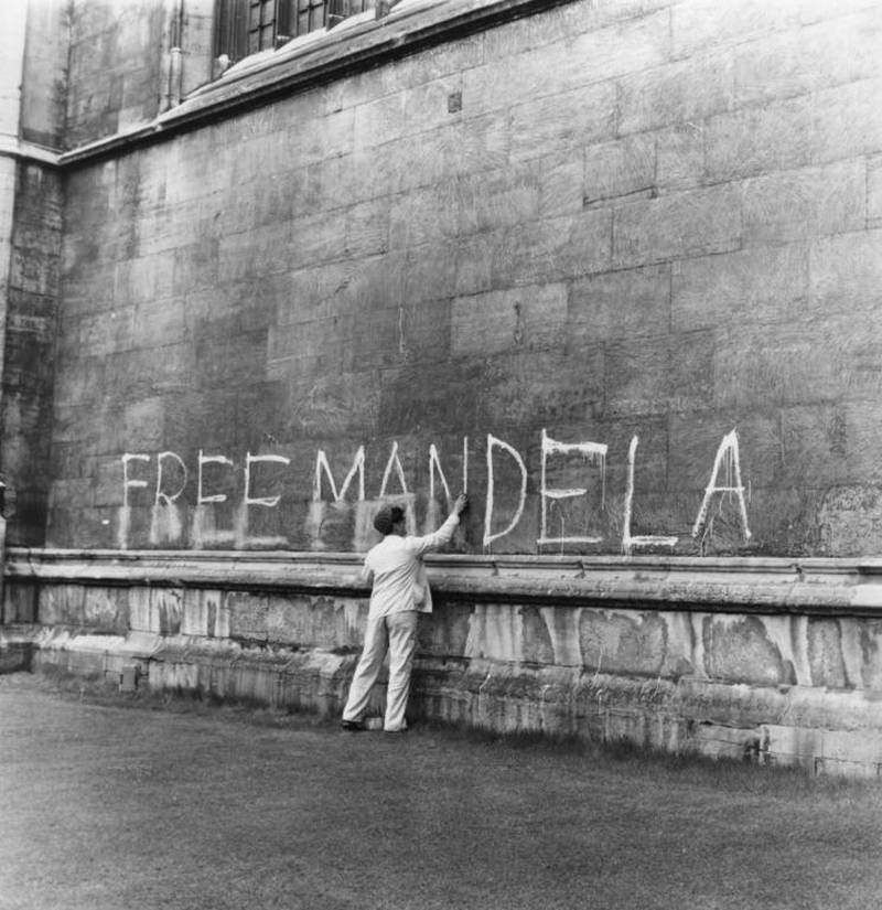 A man washing a ‘Free Mandela’ slogan off the side of King’s College Chapel in Cambridge, UK. Peter Dunne / Getty Images
