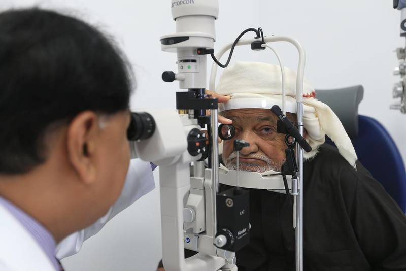 Dr Najmi Rahman checks a patient’s eyes during a screening at the new Oud Al Touba Healthcare Centre in Al Ain. Ravindranath K / The National