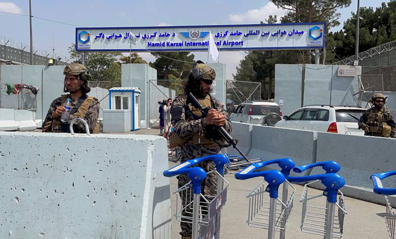 Taliban forces stand guard at the entrance gate of the airport a day after the withdrawal of US troops from Kabul. Reuters