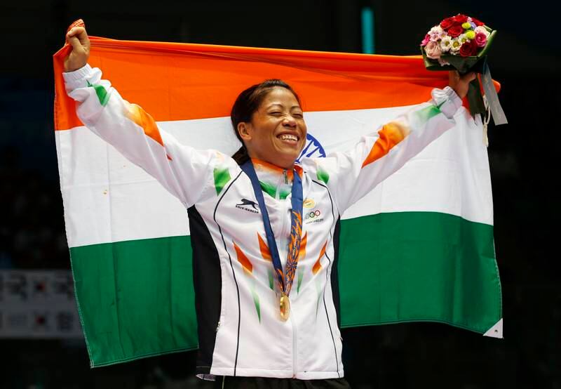 In this October  1, 2014, file photo, India's Mary Kom holds the Indian national flag and celebrates her gold medal in the women's flyweight (48-51kg) final boxing match at the 17th Asian Games in Incheon, South Korea.