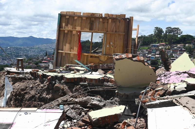 Dozens of houses were destroyed in the Guillen neighbourhood in north-east Tegucigalpa in Honduras, following a chain of landslides triggered by heavy rains hitting the capital.  AFP