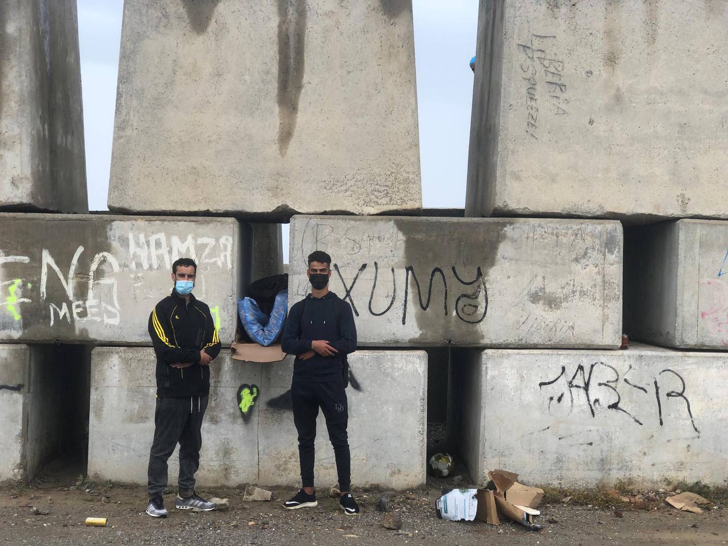 Yahya Aarab (left), 25, from Tangier and Yassine Yerrou, 17, from the northern Morocco city of Tetouan sleep on Ceuta's sea defences. Karen Rice