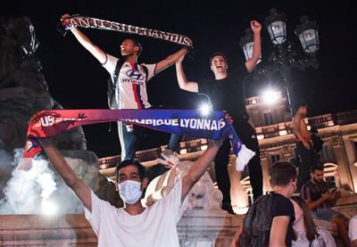 Supporters celebrate in Lyon after their team qualified for the quarter-finals of the Champions League. AFP