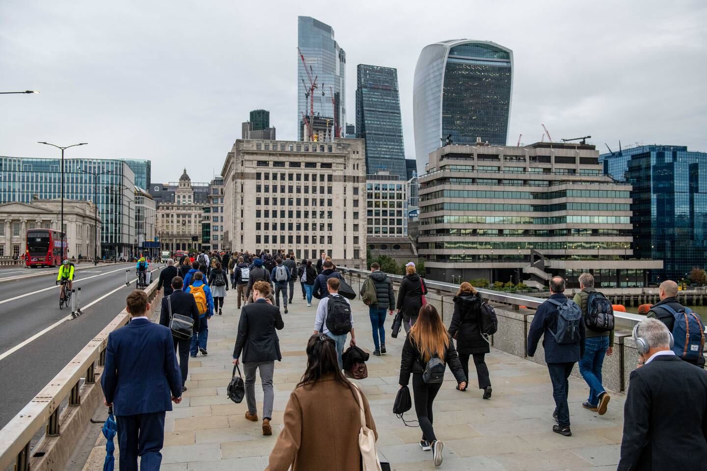 Commuters make their way over London Bridge towards the City of London, as workers slowly return to the city. Bloomberg