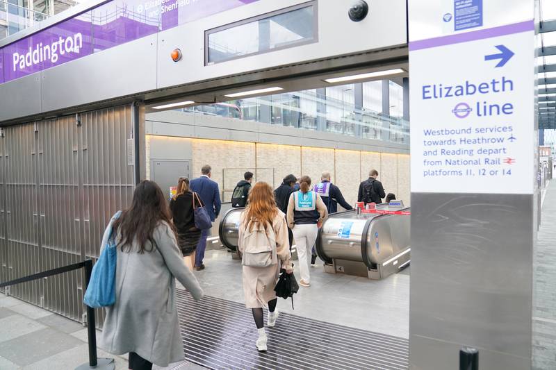 Passengers travel down to the Elizabeth line platforms at Paddington Station. PA