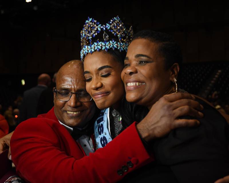 Miss World 2019 Miss Jamaica Toni-Ann Singh (C) reacts with her mother, Jahrine Bailey (R) and her father, Bradshaw Singh (L). EPA