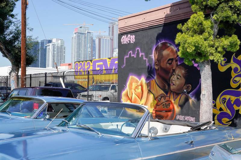Fans gather around a mural of late NBA great Kobe Bryant and his daughter Gianna Bryant during a public memorial for them and seven others killed in a helicopter crash, at the Staples Center in Los Angeles, California, US, February 24, 2020. REUTERS