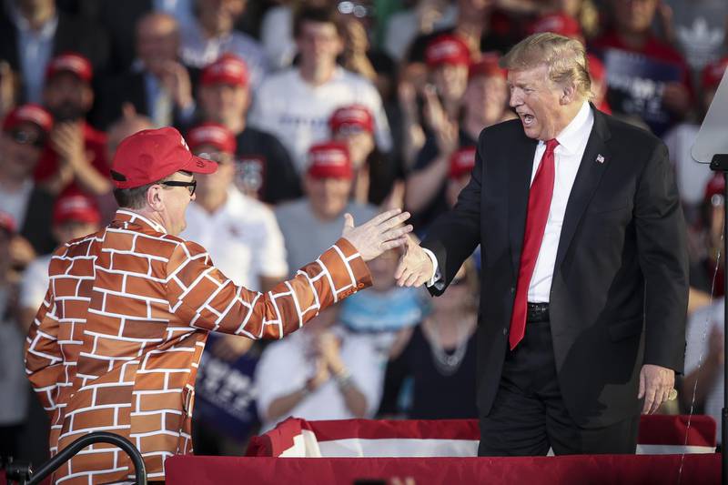 MONTOURSVILLE, PA - MAY 20: U.S. President Donald Trump calls up Blake Marnell, wearing a jacket with bricks representing a border wall, to the stage during a 'Make America Great Again' campaign rally at Williamsport Regional Airport, May 20, 2019 in Montoursville, Pennsylvania. Trump is making a trip to the swing state to drum up Republican support on the eve of a special election in Pennsylvania's 12th congressional district, with Republican Fred Keller facing off against Democrat Marc Friedenberg.   Drew Angerer/Getty Images/AFP