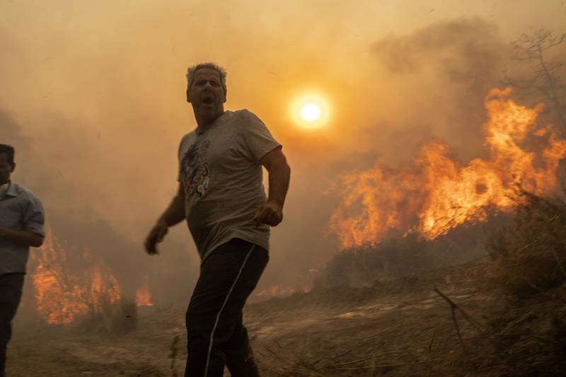 Trees burn as a wildfire spreads through Gennadi in Rhodes, south-eastern Greece, in July. AP