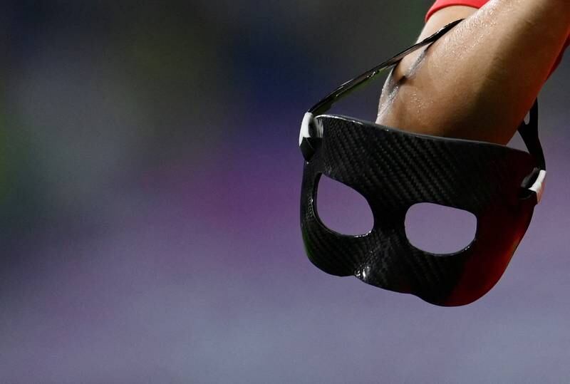 South Korea's Son Heung-min holds his protective mask after the match. Reuters