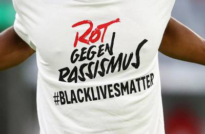 Kingsley Coman of Bayern Munich wears a shirt to warm up in with a message in support of the Black Lives Matter campaign. Getty