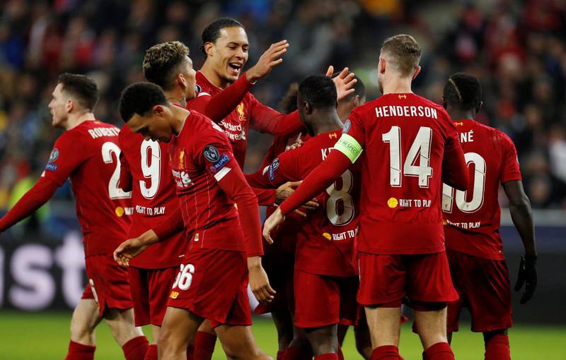 Liverpool's Naby Keita celebrates scoring their first goal with Virgil van Dijk and teammates. Reuters
