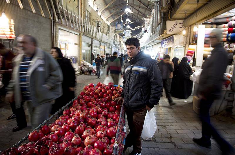 An Iranian vendor sells pomegranates at Tehran's main bazaar on January 2. Maryam Rahmanian for The National