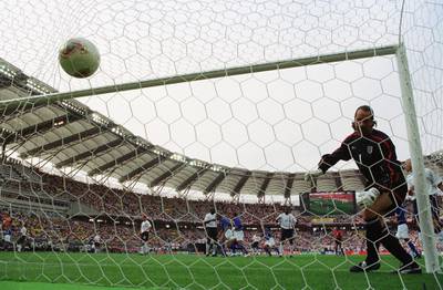 SHIZUOKA - JUNE 21:  David Seaman of England can only watch in horror as an amazing free-kick from Ronaldinho of Brazil goes in to the net for the winning goal during the FIFA World Cup Finals 2002 Quarter Finals match played at the Shizuoka Stadium Ecopa, in Shizuoka, Japan on June 21, 2002. David Seaman, who was capped 75 times for England, announced his decision to retire January 13, 2004 due to a long-term shoulder injury. (Photo by David Cannon/Getty Images)