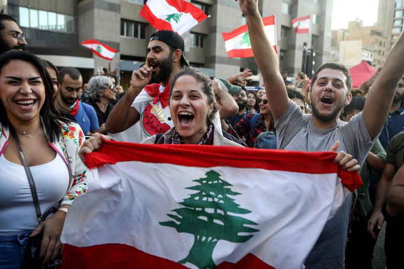 Protesters celebrate the resignation of Prime Minister Saad Hariri in Beirut, Lebanon. AFP