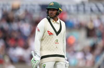 Usman Khawaja of Australia leaves the pitch after being dismissed lbw by Chris Woakes. Getty