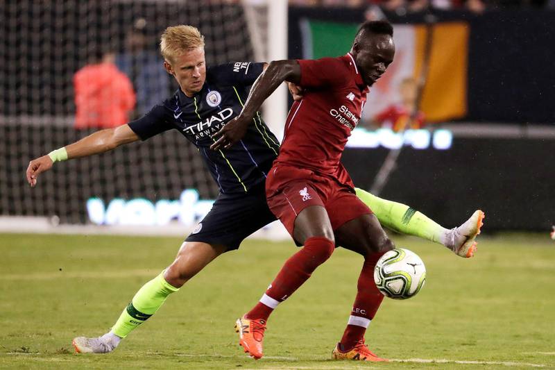 Liverpool's Sadio Mane tries to control the ball as Manchester City's Oleksandr Zinchenko defends. AP Photo