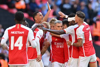 Arsenal's Leandro Trossard, centre, celebrates with teammates after his deflected equaliser. AFP