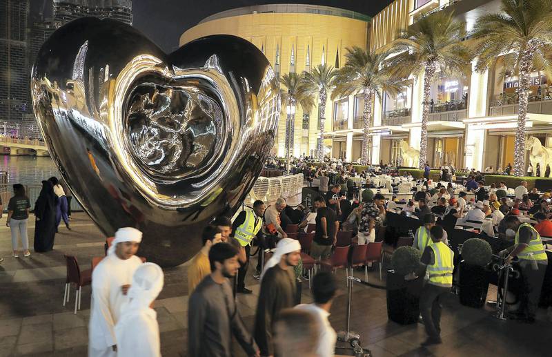 DUBAI , UNITED ARAB EMIRATES – Dec 31 , 2019 : People are coming to the restaurants outside the Dubai Mall to watch the NYE 2020 fireworks at Burj Khalifa in Dubai. ( Pawan Singh / The National ) For News/Online/Instagram