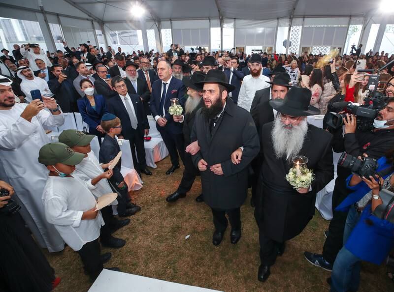 UAE Rabbi Levi Duchman, centre, is escorted to the wedding canopy by his father, Rabbi Sholom Duchman, and father-in-law, Rabbi Menachem Hadad, chief rabbi of Brussels. Victor Besa / The National