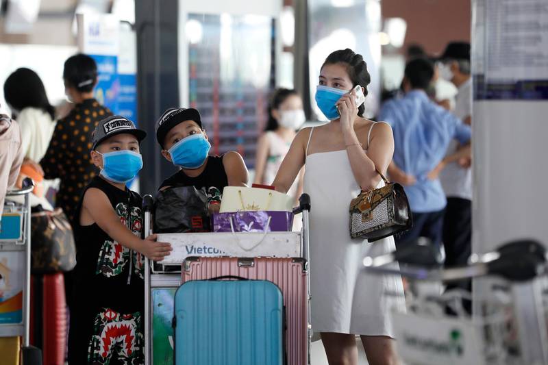 People wear face masks at Noi Bai International Airport in Hanoi, Vietnam. EPA