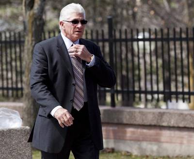 Former Toronto Maple Leafs captain Rick Vaive adjusts his tie as he enters a courthouse in Newmarket, Ontario. Vaive has withdrawn from a class-action lawsuit that claims the NHL has not done enough to protect players from concussions. Michelle Siu / AP Photo