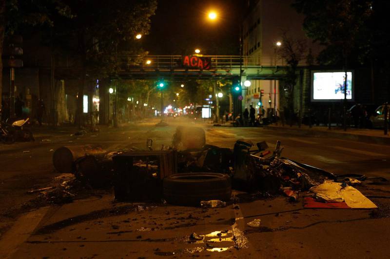 A destroyed motor scooter and other burnt waste have been left behind by protesters at Porte de Clichy, in the northwest of Paris, on June 2, 2020 following a demonstration against police violence and in memory of late US citizen George Floyd who died a week before after a Minneapolis police officer knelt on his neck. Several US cities have deployed the guard in the face of angry protests against police brutality following the killing of unarmed black man George Floyd by police during an arrest in Minneapolis last week. / AFP / GEOFFROY VAN DER HASSELT
