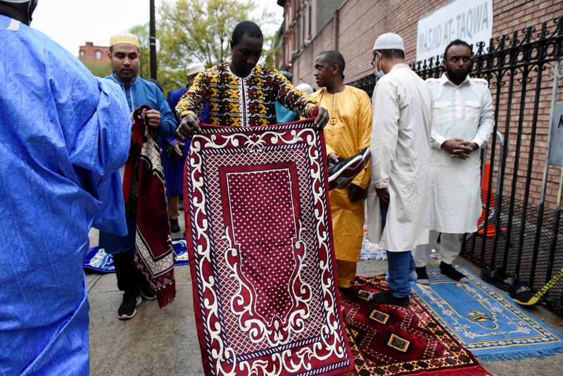 A man holds a prayer mat during Eid Al Fitr. Reuters