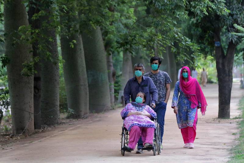 People walk in a park after it was reopened with the easing of the lockdown against the spread of the COVID-19 coronavirus in Lahore, Pakistan. Countries around the world are taking increased measures to stem the widespread of the SARS-CoV-2 coronavirus which causes the Covid-19 disease.  EPA
