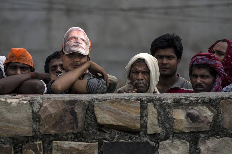 Supporters listen to a speech by BJP leader Narendra Modi at a rally on May 10,  2014 in Robertsganj. Kevin Frayer/Getty Images
