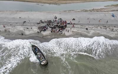 A boat carrying Rohingya stranded on Lampanah beach, Aceh province. The UN says the official recorded drowning toll of 350 in 2022 was the 'tip of the iceberg', with many more feared dead. Reuters