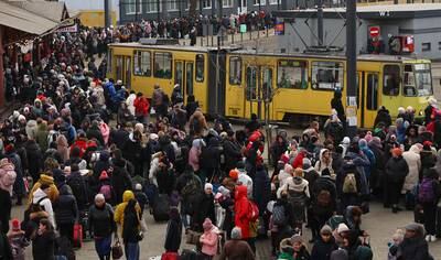 Refugees intent on fleeing Ukraine wait for hours to board a train from Lviv to Poland. Reuters