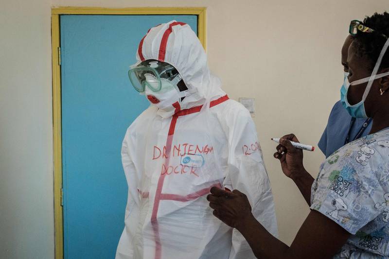 A doctor and laboratory specialists prepare before visiting the ward for quarantined people who had close contact with the first Kenyan coronavirus patient at the Infectious Disease Unit of Kenyatta National Hospital in Nairobi, Kenya. AFP
