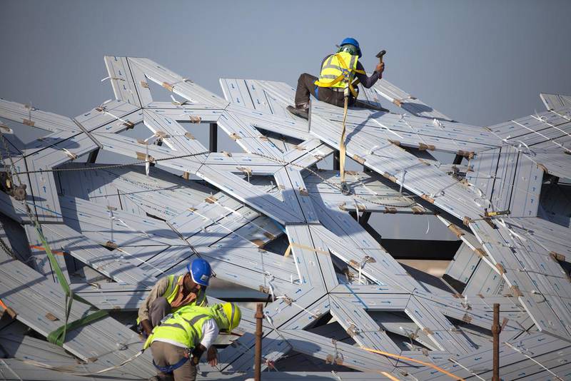 December 12, 2013: men work on a mock-up section of the dome at the Louvre Abu Dhabi construction site. Construction has begun on the steel dome with an installation of its first super-sized skeleton piece. Silvia Razgova / The National