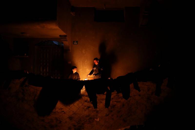 Palestinians warm themselves by a fire during a power cut at their house in Beit Lahiya in the northern Gaza Strip. Reuters