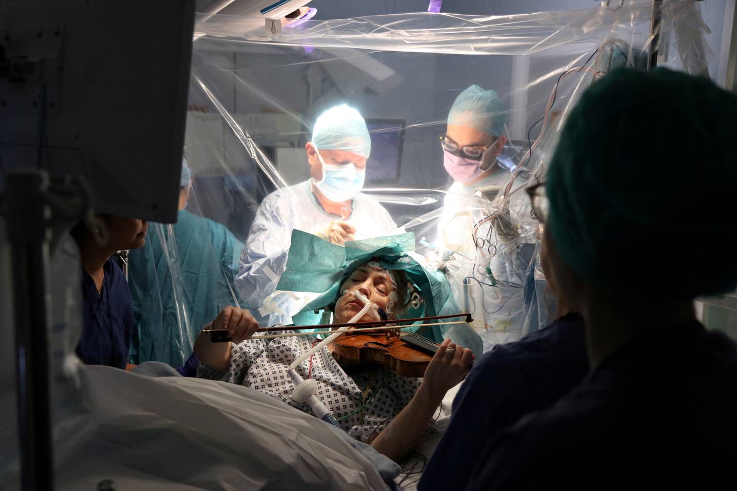 A patient Dagmar Turner, 53, plays violin while surgeons remove her brain tumour at King's College Hospital in London, Britain, January 31, 2020 in this handout image obtained by Reuters on February 19, 2020. King's College Hospital/Handout via REUTERS THIS IMAGE HAS BEEN SUPPLIED BY A THIRD PARTY. NO RESALES. NO ARCHIVES MANDATORY CREDIT     TPX IMAGES OF THE DAY