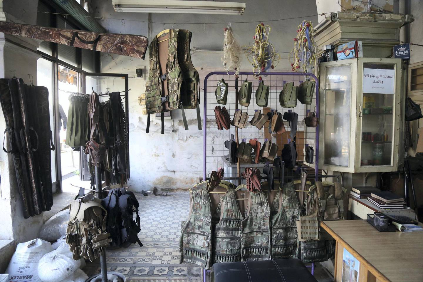Bulletproof vests hanging on racks in a gun shop in central Idlib. The National