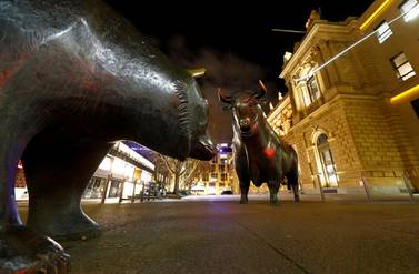 Bull and bear symbols for successful and bad trading are seen in front of the German stock exchange. With pandemic concerns still weighing on markets, investors are unsure if the global economy will spring back to life, or if they should stick to defensive mode in case it drags on. Reuters