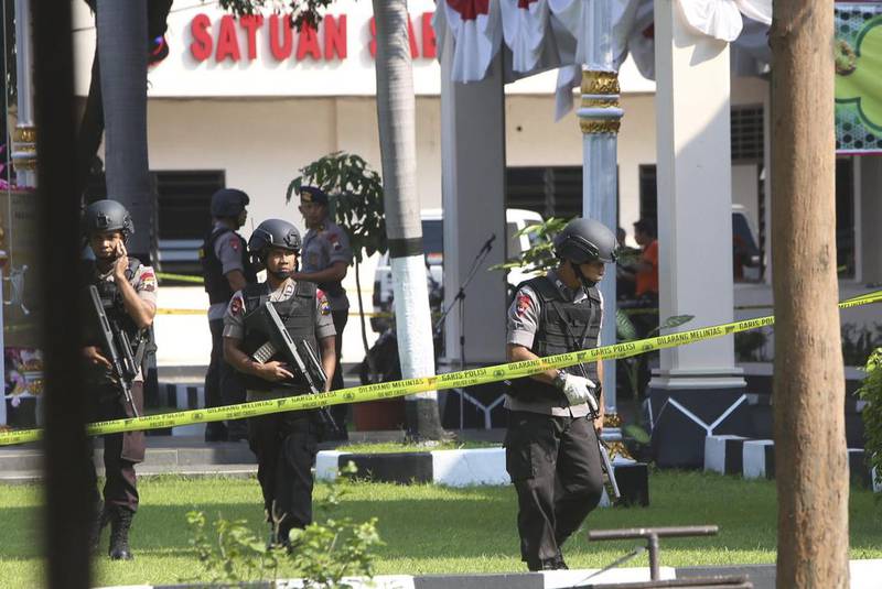 In this July 5, 2016 photo, members of the police bomb squad examine the surrounding area where a suicide bomber blew himself up at the local police headquarters in Solo, Central Java, Indonesia. Experts say the threat from the militants, spread across predominantly Muslim Indonesia, Malaysia and the southern Philippines, should not be underestimated. AP Photo
