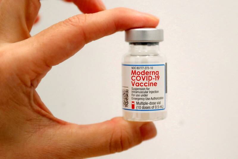 A health worker holds a vial of the Moderna Covid-19 vaccine at a pop-up in Manhattan, New York City. Reuters