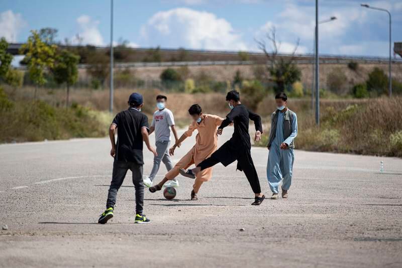 Afghan youth play football at a reception centre for Afghan refugees organised by the Italian Red Cross in Avezzano, Italy.  Italy is hosting almost 5,000 Afghan refugees who were flown from Kabul after the Taliban claimed control of the capital. EPA
