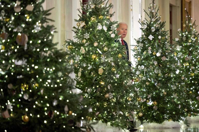 US President Joe Biden arrives to deliver a Christmas address from the Cross Hall of the White House in Washington. AFP