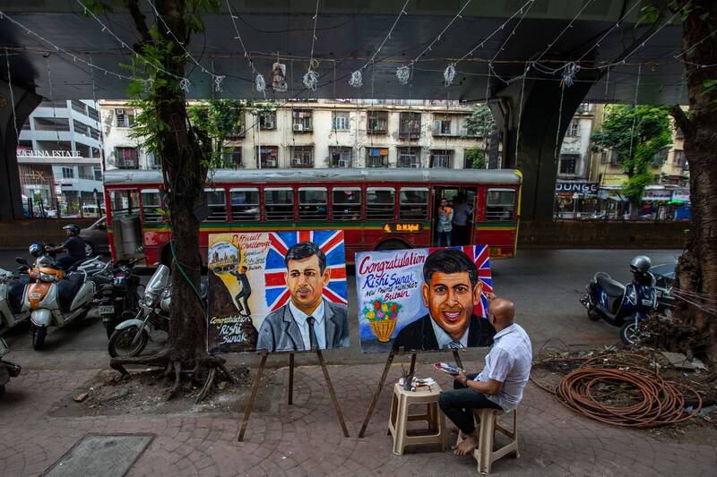 An Indian artist from Gurukul School of Art makes a painting to congratulate Rishi Sunak on becoming British prime minister, in Mumbai, India. EPA