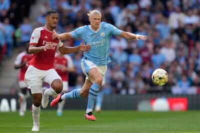 Arsenal's William Saliba, left, vies for the ball with Manchester City's Erling Haaland during the Community Shield final. AP